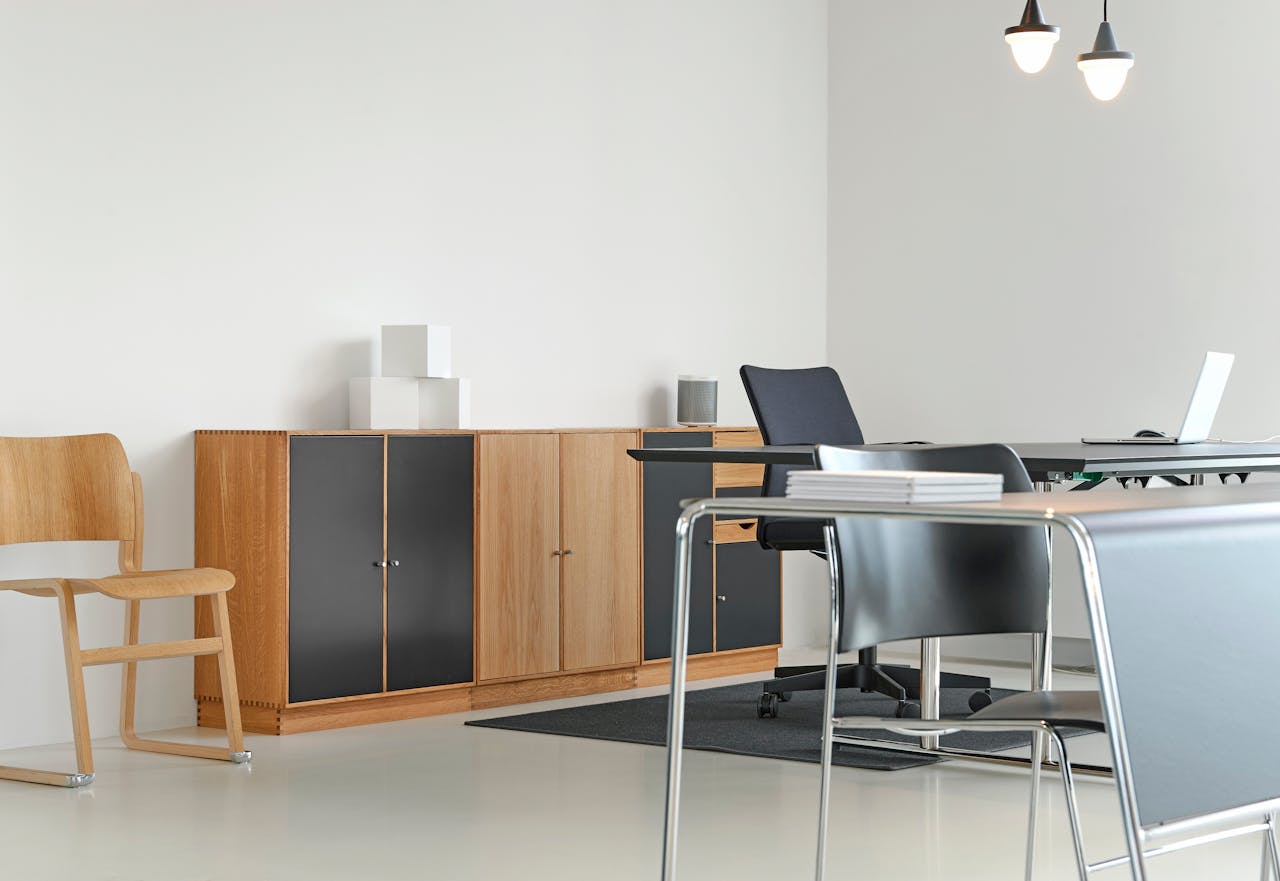 about-bg A clean and organized modern office space with stylish furniture and decor.